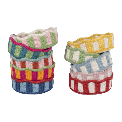 Stacks of colorful striped fabric rolls on a white background