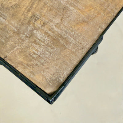 Close-up of a ceramic tile with a beige and brown pattern on a light gray background