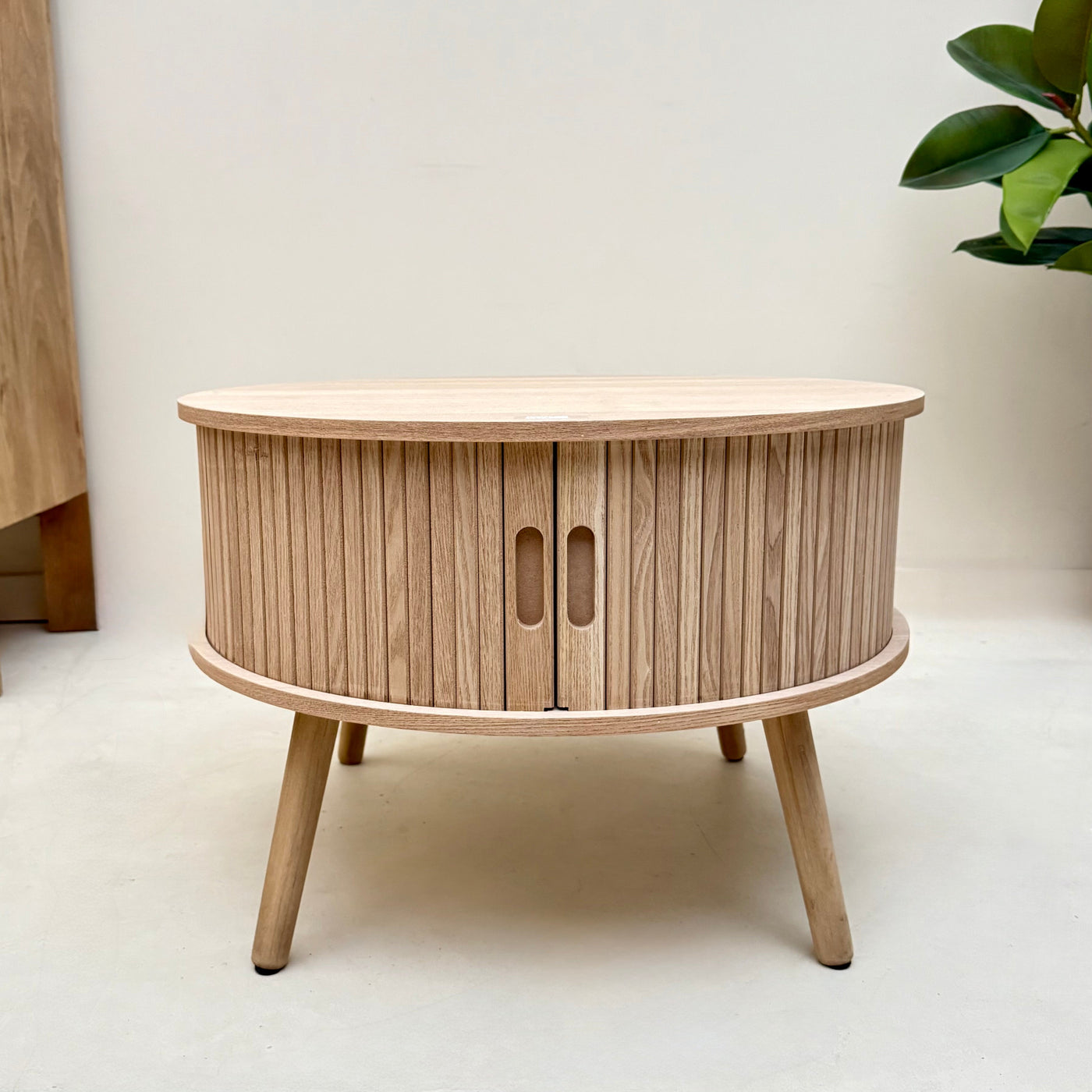 Wooden side table with a natural finish on a white background