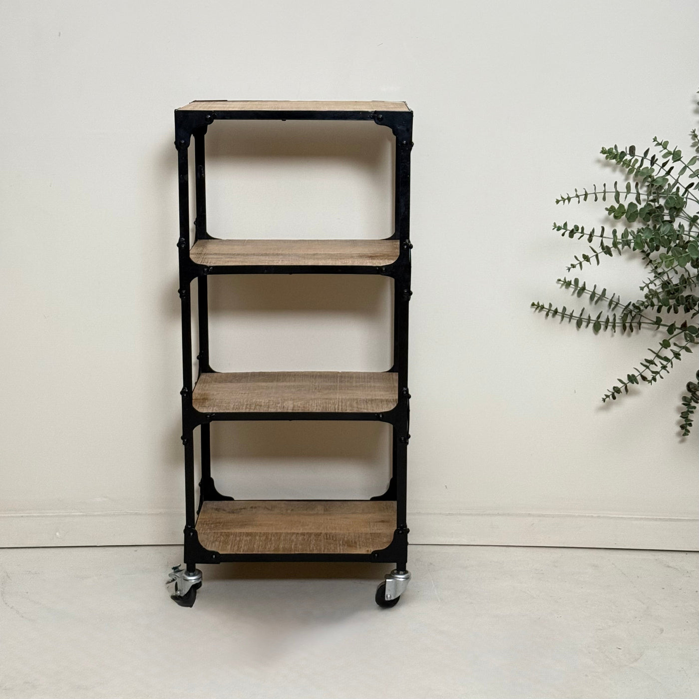 Bookshelf with wooden shelves and black metal frame on a white floor.