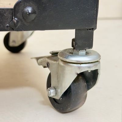 Close-up of a caster wheel on a piece of furniture.