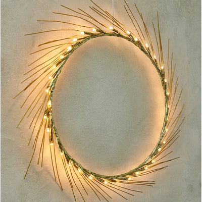 Decorative wreath with lights on a plain wall