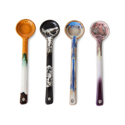 Four ceramic spoons with unique, multicolored patterns on a white background