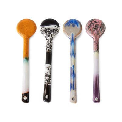 Four decorative spoons with unique patterns on a white background