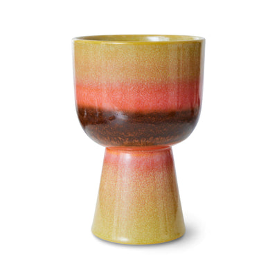 Multicolored ceramic cup with a gradient design on a white background