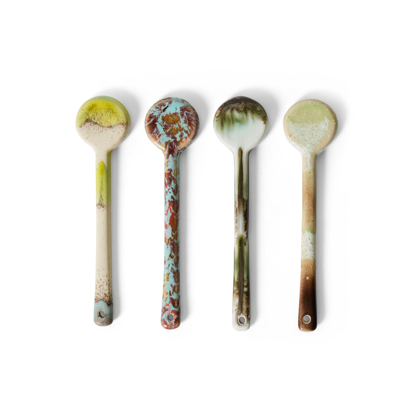 Four ceramic spoons with rustic, earthy glaze patterns on a white background