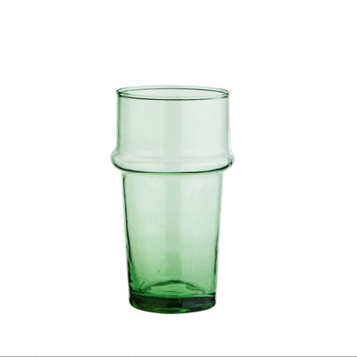 Green glass cup on a white background