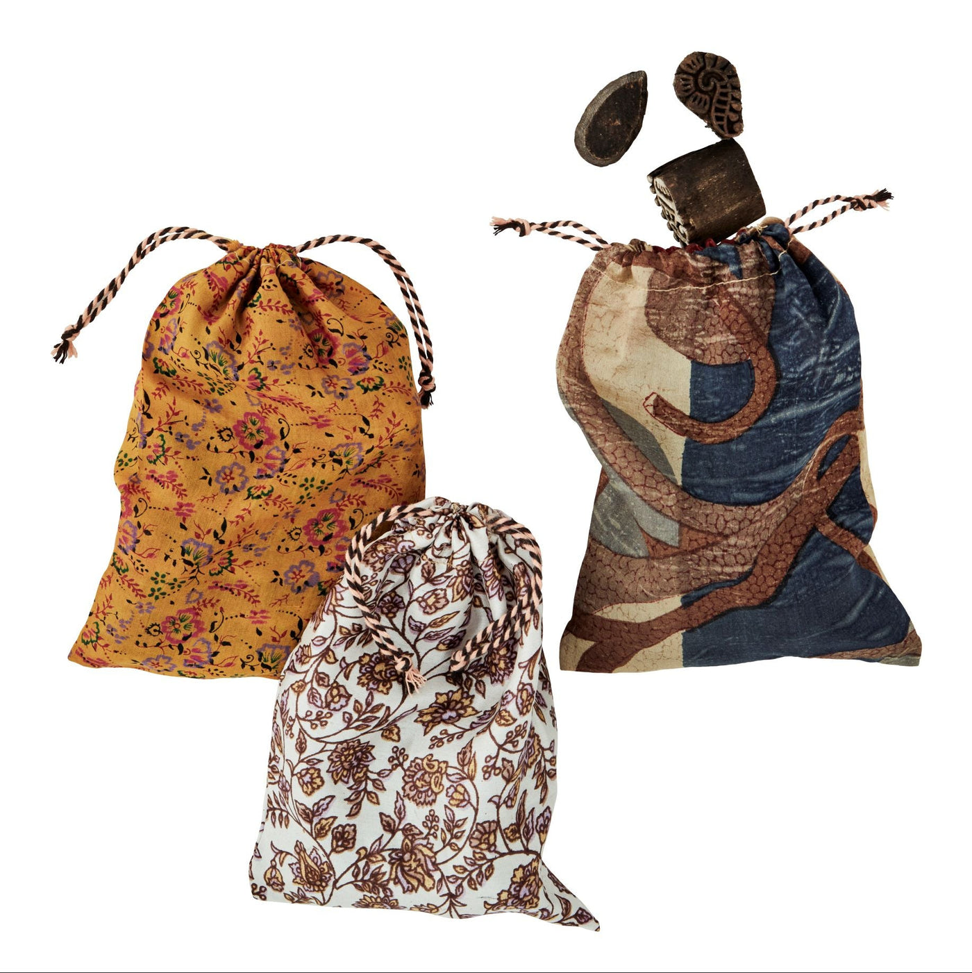 Three drawstring bags with floral, abstract, and patterned designs on a white background.