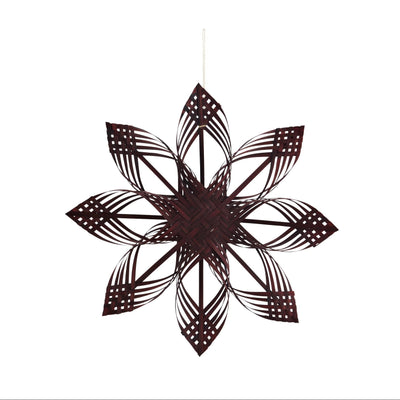 Decorative metal wall art with a starburst pattern on a white background