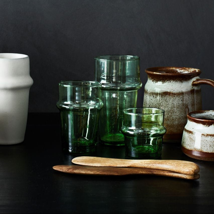 Collection of ceramic and glassware on a dark surface with a dark background