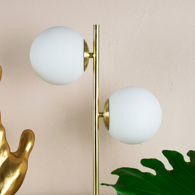 gold and white orb table lamp close up